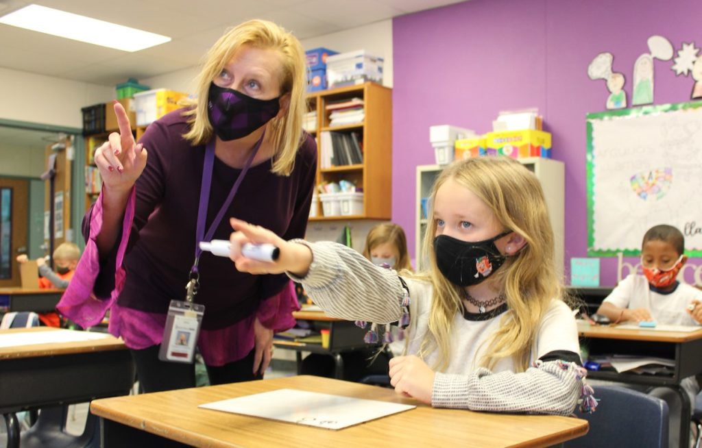 Denise Sharp, principal at Forest Creek Elementary in Round Rock ISD, is photographed wearing a face mask as she gestures with students in the classroom.