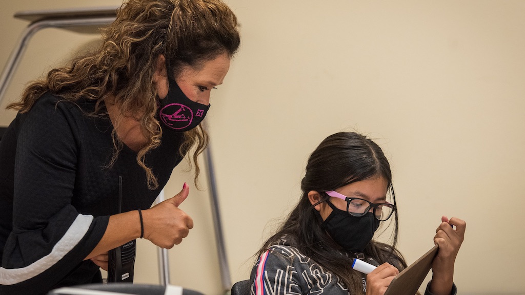 Anitra Crisp, a principal at McNair Middle School in Southwest ISD, is photographed on campus interacting with a student during a classroom exercise.