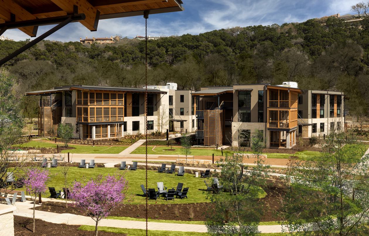 A photograph of the completed Campus on Lake Austin encompassing the meadow and overnight guest residences taken in 2021.
