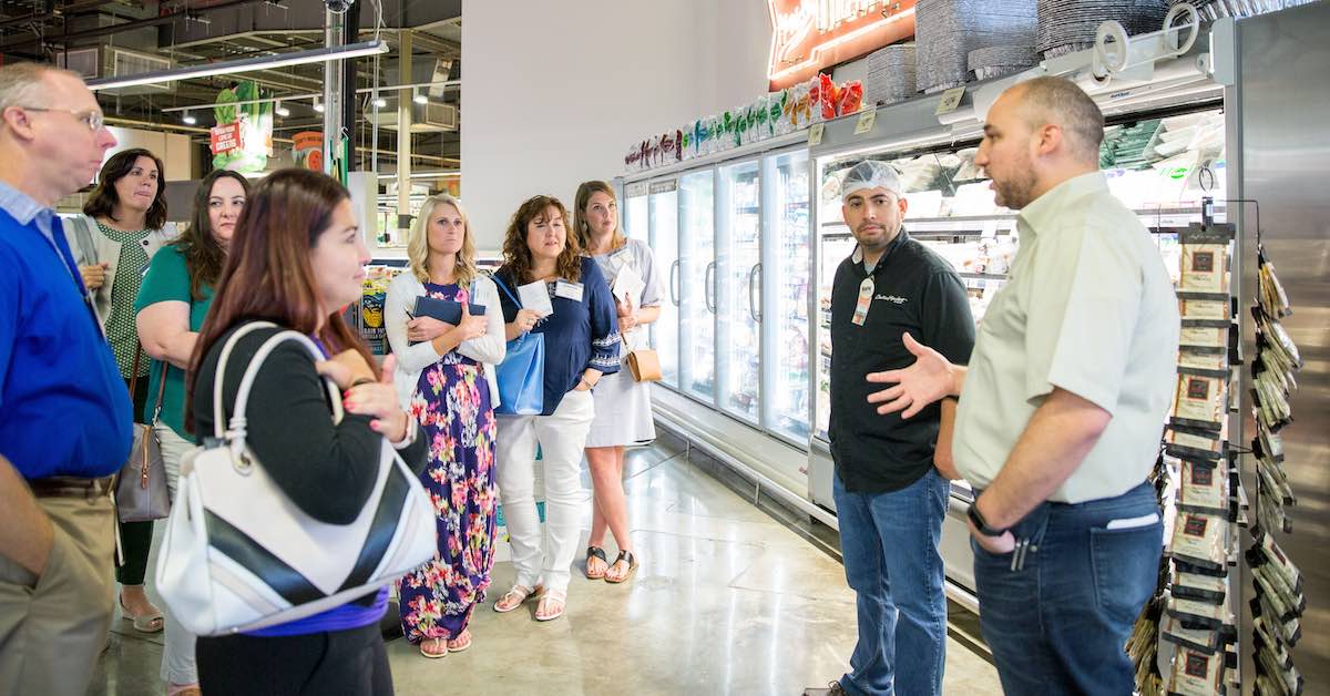 Campus leaders in the Holdsworth Partnership are photographed during a session at Central Market to learn more about the company’s leadership development systems.