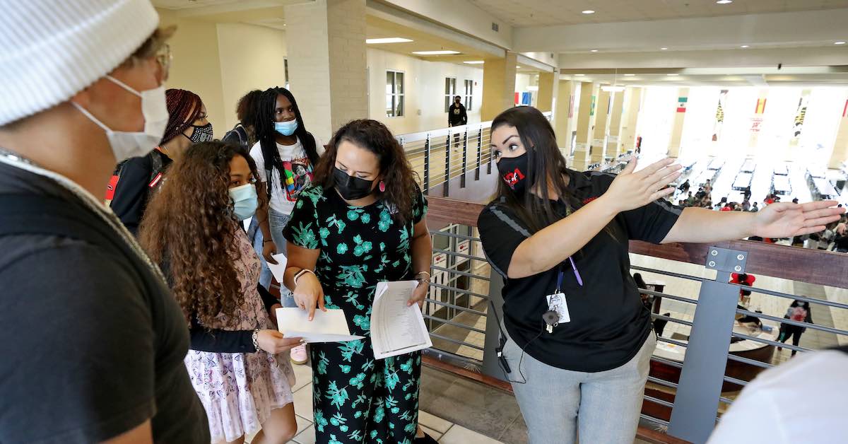 Priscilla Alfaro, Principal, Wagner High School, is photographed directing students in a campus hallway.