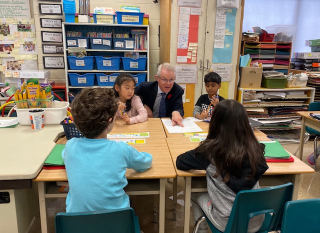 Dr. John Malloy, Director of the Toronto District School Board pictured with younger students.