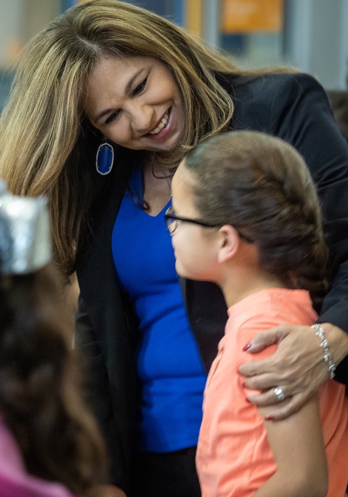 Sylvia Denise Acuña, Principal, Sky Harbour Elementary of Southwest ISD is photographed with her arm around a student.