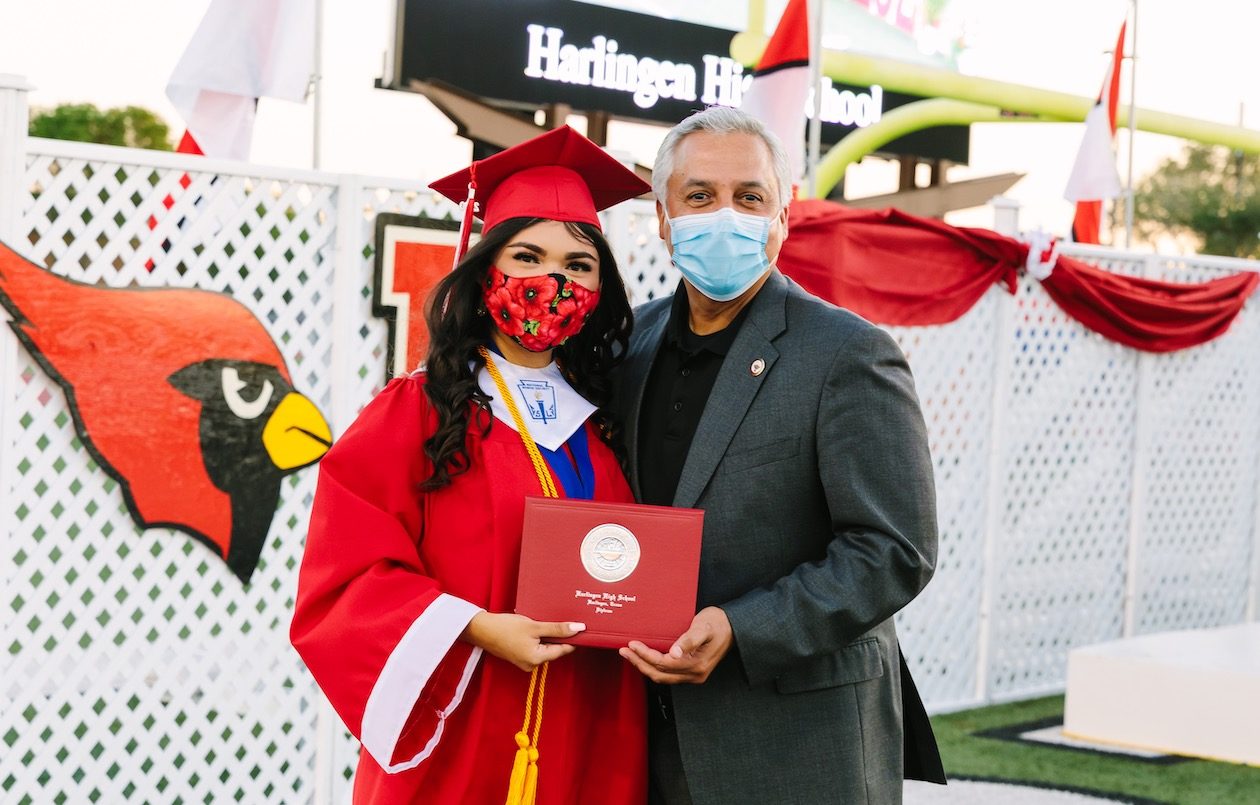 Dr. Art Cavazos, Harlingen CISD’s superintendent, poses with a student during graduation.