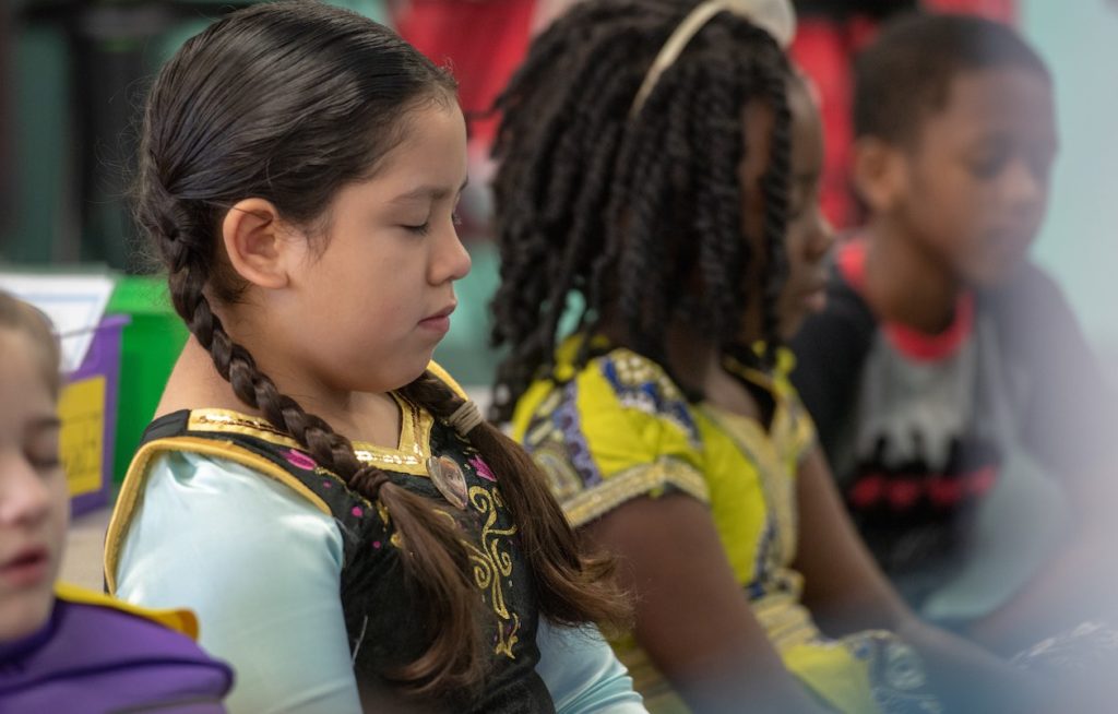 Students are photographed in class at Hale Elementary School in Arlington ISD sitting quietly with their eyes closed.
