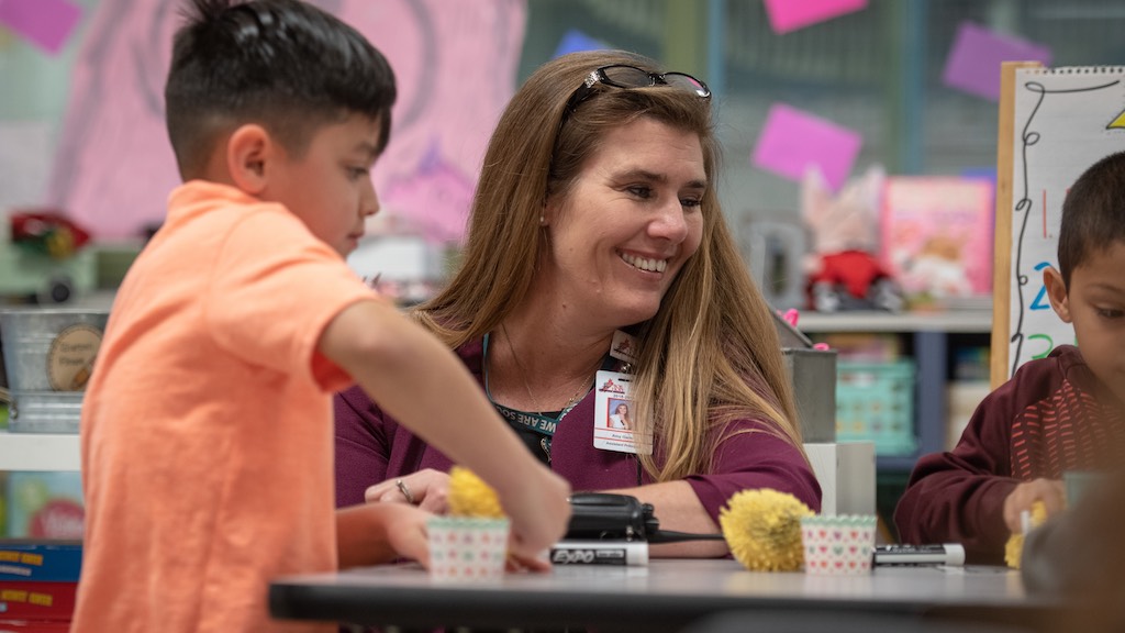 Amy Garza, principal of Medio Creek Elementary School in Southwest ISD is photographed on campus smiling and interacting with students.
