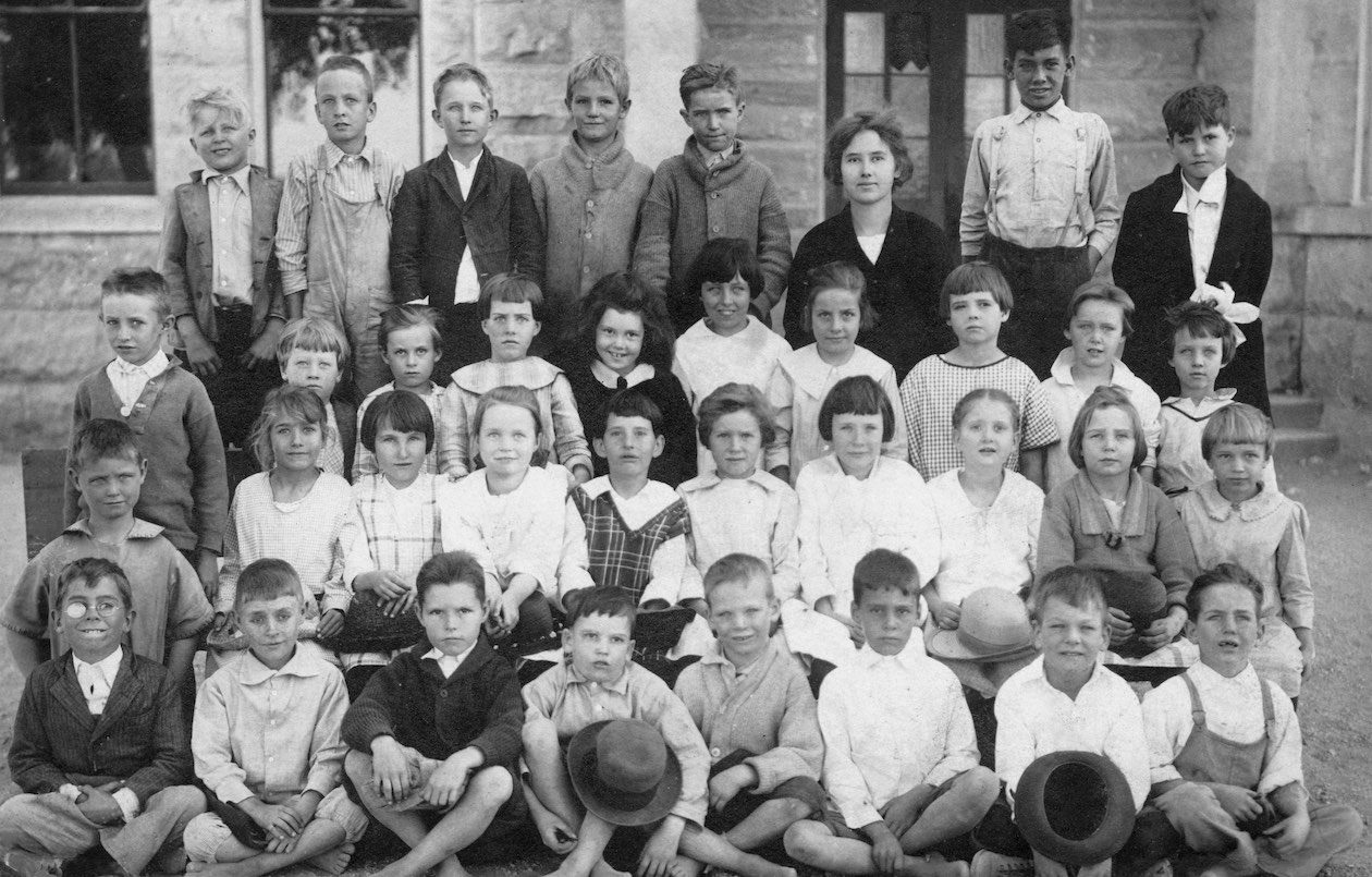 Mary Elizabeth Holdsworth, who taught school in the 1920s in Center Point, Texas, near Kerrville, is photographed with her students.