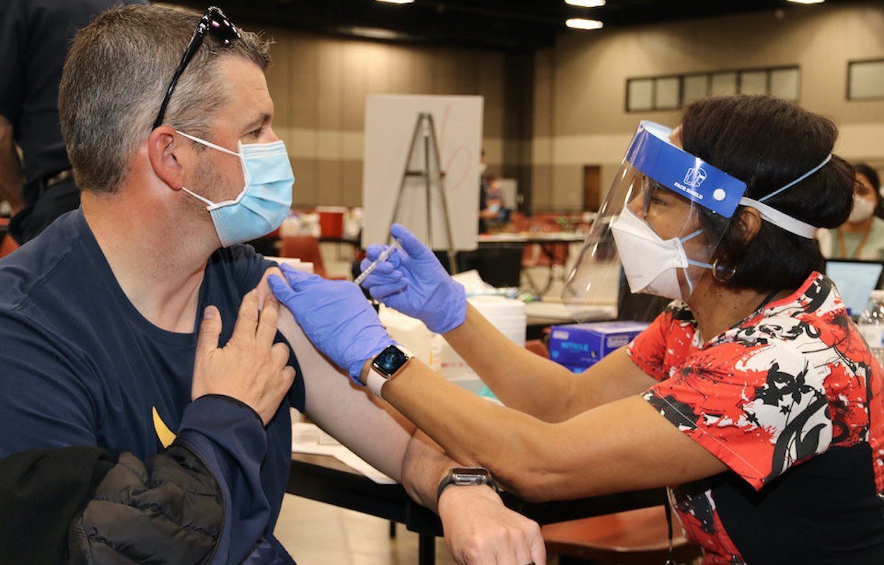 Nurse Tyler from Ashworth Elementary School in Arlington ISD is photographed giving COVID vaccinations to AISD employees.