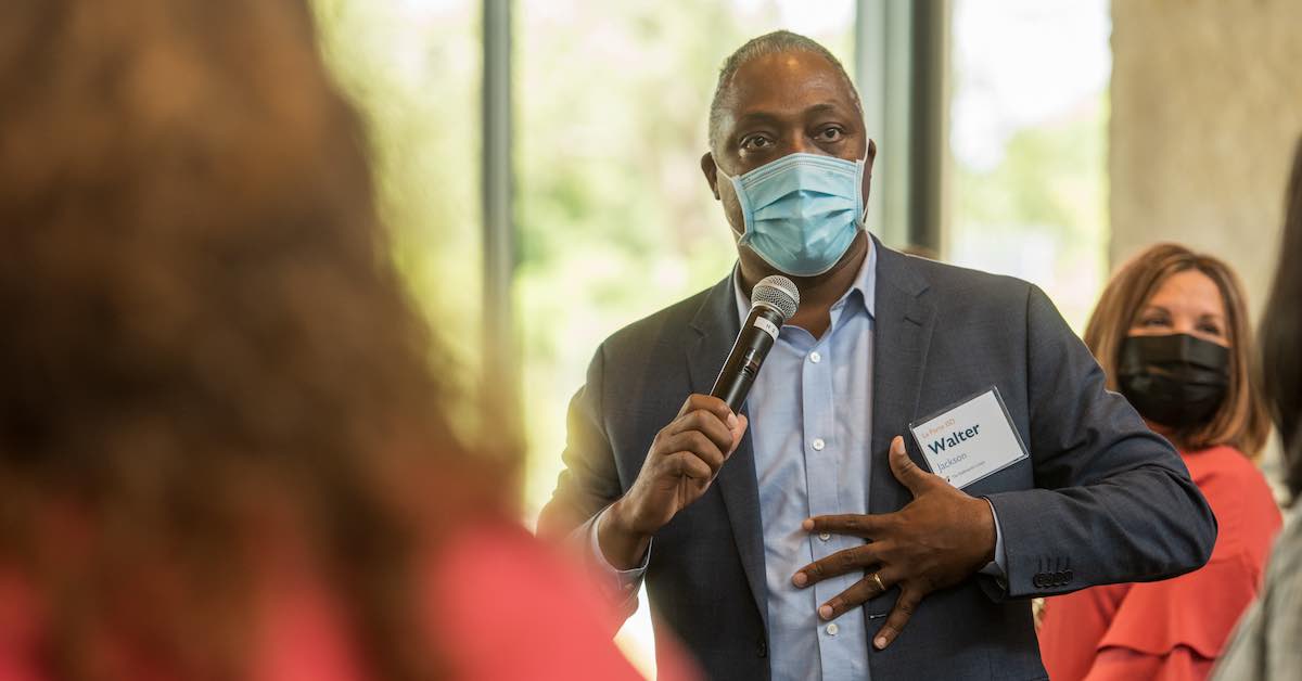 Walter Jackson of La Porte ISD speaks into a microphone during a Holdsworth Center Leadership Collaborative session at the Campus on Lake Austin.