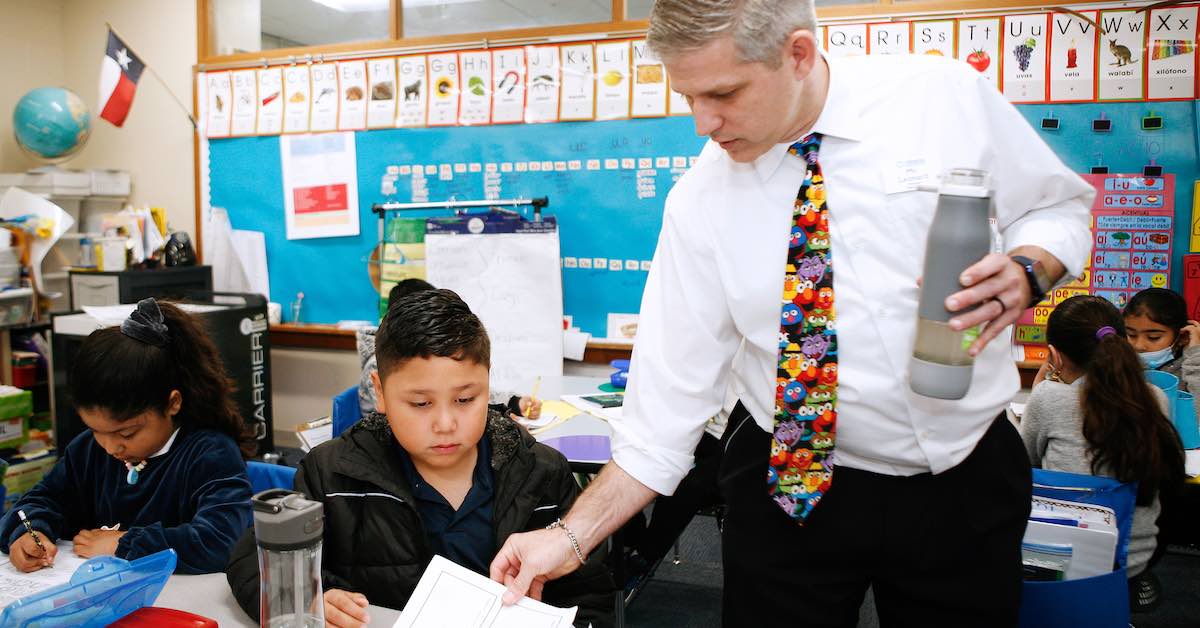 Principal Josh Leonard interacts with a student in the classroom at Blanton Elementary school in Arlington ISD.