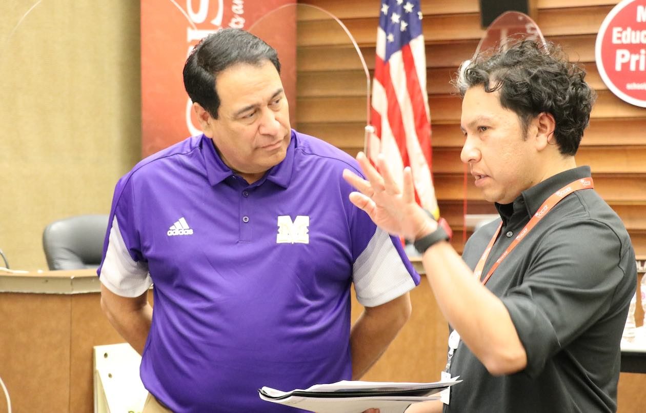 Roland Hernandez, superintendent of Corpus Christi ISD, is pictured listening to a colleague.