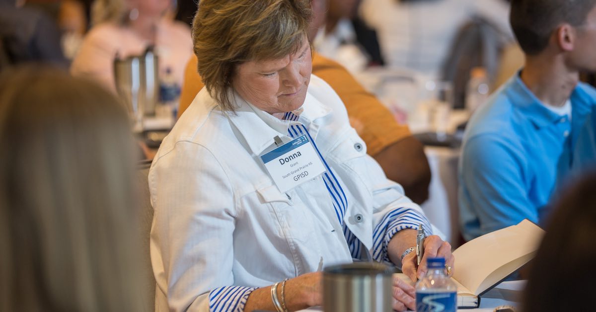 Donna Grant of Grand Prairie ISD is photographed taking notes during a Holdsworth Center leadership session at the Campus on Lake Austin.