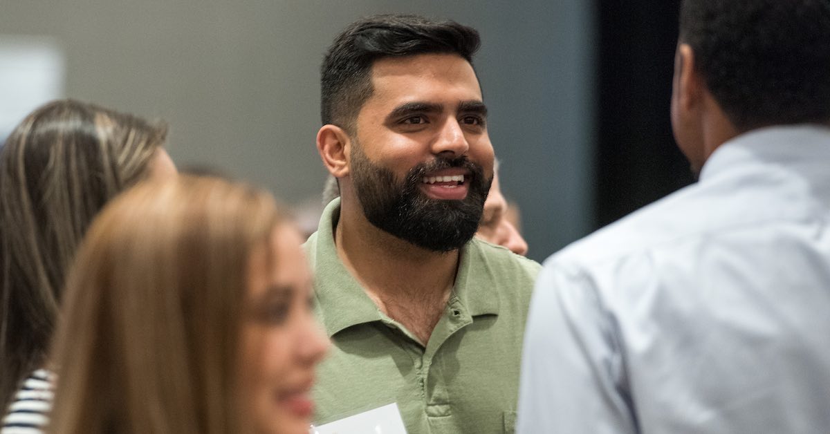 Parvinder Singh of Arlington ISD is pictured smiling during a discussion with colleagues during a Holdsworth Center leadership session at the Campus on Lake Austin.