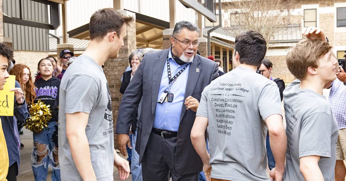 Gabe Trujillo, superintendent of Nacogdoches ISD, is photographed interacting with a group of students on campus.